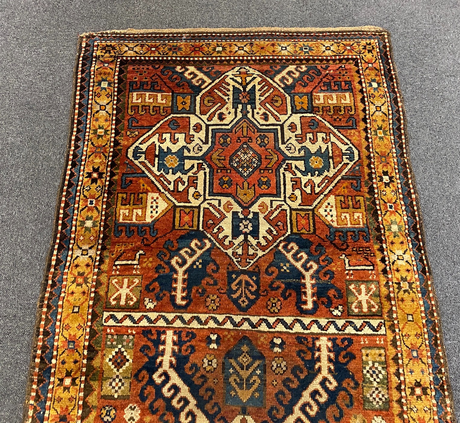 A Kazak red ground rug, 240 x 108cm